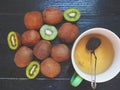 Kiwi and a cup of green tea on a black background