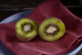 Kiwi cut in two halfs in a wooden table Royalty Free Stock Photo