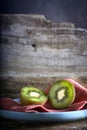 Kiwi cut in two halfs in a wooden table