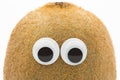 Kiwi face with googly eyes on white background