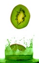 Kiwi falling in juice. Royalty Free Stock Photo