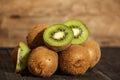 Kiwi fresh whole and halves on a black wooden table. Kiwi fruit is useful. Royalty Free Stock Photo