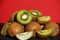 Kiwi fresh whole and halves on a black wooden table. Kiwi fruit is useful. Royalty Free Stock Photo