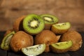 Kiwi fresh whole and halves on a black wooden table. Kiwi fruit is useful. Royalty Free Stock Photo