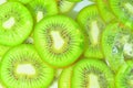 Kiwi fruit close-up in liquid with bubbles. Slices of green ripe kiwi fruit in water. Close-up fresh slices of green Royalty Free Stock Photo