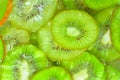 Kiwi fruit close-up in liquid with bubbles. Slices of green ripe kiwi fruit in water. Close-up fresh slices of green Royalty Free Stock Photo