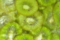 Kiwi fruit close-up in liquid with bubbles. Slices of gren ripe kiwi fruit in water. Close-up fresh slices of green kiwi Royalty Free Stock Photo