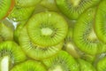 Kiwi fruit close-up in liquid with bubbles. Slices of gren ripe kiwi fruit in water. Close-up fresh slices of green kiwi Royalty Free Stock Photo