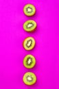 Kiwi fruit pattern on pink colored background, minimal flat lay style, copy space.