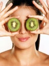 Kiwi fruit on young woman eyes. Royalty Free Stock Photo