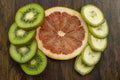 Kiwi grapefruit banana beautifully arranged fresh juicy vitamins tropical on wood