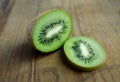 Kiwi, greencolor, fruit on brown wooden background.