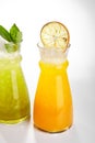 Kiwi and orange fruit lemonade glasses close up