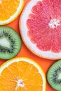 Kiwi, orange and grapefruit. Summer juicy background. Tropical fruits close-up cutaway. Bright pattern