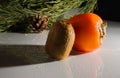 Kiwi, persimmon on a white background Fresh fruit in the water