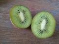 Kiwi pieces on a wooden Background