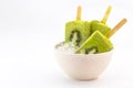 kiwi popsicle isolated on white background made with fresh fruits inside bowl with ice Royalty Free Stock Photo