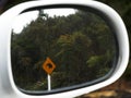 Kiwi road sign reflected in a car mirror