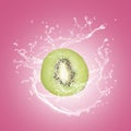Kiwi slice with water splash isolated on pink blackground Royalty Free Stock Photo