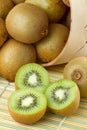 Kiwi sliced and whole fruits, basket