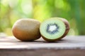 kiwi slices close up and fresh whole kiwi fruit wooden and nature green background