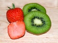 Kiwi slices strawberry slices on a broad. Royalty Free Stock Photo