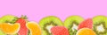 Kiwi slices, tangerines, strawberries on pink panoramic background. Fruits banner Royalty Free Stock Photo