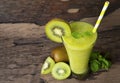 Kiwi yogurt smoothies juice,beverage healthy the taste yummy In glass drink episode morning on wood background. Royalty Free Stock Photo