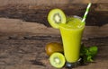 Kiwi yogurt smoothies juice,beverage healthy the taste yummy In glass drink episode morning on wood background. Royalty Free Stock Photo