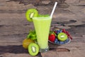 Kiwi yogurt smoothies juice and kiwi green fruit for breakfast in the morning on wood background.