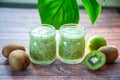 Kiwi smoothies in glass cups on a wooden Royalty Free Stock Photo