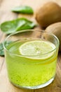 Kiwi spinach green smoothie with lemon in glass Royalty Free Stock Photo