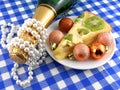 Kiwi tasty cake close up at plate, champagne bottle, diamonds and christmas balls Royalty Free Stock Photo
