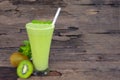 Kiwi yogurt smoothies juice,beverage healthy the taste yummy In glass drink episode morning on wood background. Royalty Free Stock Photo
