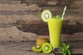 Kiwi yogurt smoothies juice and kiwi green fruit for breakfast in the morning on wood background.