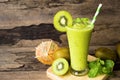 Kiwi yogurt smoothies juice and kiwi green fruit for breakfast in the morning on wood background.