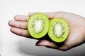 Kiwifruit Healthy eating and diet Topic Human hand holding a half kiwi isolated on a white background in the studio Royalty Free Stock Photo