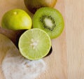 Kiwifruit and lemon with salt on wood cutting board Royalty Free Stock Photo