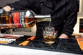 Kiyv, Ukraine, November 22, 2020. Bartender pours single malt Auchentoshan `American Oak` Scotch Whiskey into a glass at the bar