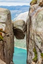 Kjeragbolten, the stone stuck between two rocks with fjord in the background, Lysefjord, Norway