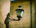 Klaipeda, Lithuania - 24 august 2021: An ancient street lighting lamp hanging on a wall. Royalty Free Stock Photo