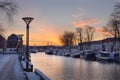 Klaipeda, Lithuania - January 14 2021. An old town, river and boats covered by winter snow, cold weather, empty streets Royalty Free Stock Photo