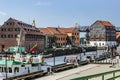 Klaipeda, Lithuania - Juny 24, 2021: Beautiful view on tourist boat, Dane river, embankment and red brick houses Klaipeda, Lithuan Royalty Free Stock Photo