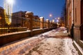 Klaipeda, Lithuania - 01 15 21: road near old historical red brick Neo-Gothic University building campus, the fence, winter snow, Royalty Free Stock Photo