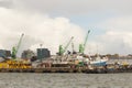 KLAIPEDA, LITHUANIA - SEPTEMBER 22, 2018: Heavy harbor jib cranes and ships on the pier in the Klaipeda Sea Port. Royalty Free Stock Photo