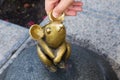 KLAIPEDA, LITHUANIA - SEPTEMBER 22, 2018: Sculpture known as Wonderful Little Mouse and human hand.