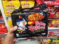 Klang,Malaysia - 10 July 2020 : Hand hold a packet of SAMYANG Hot Chicken Flavor Instant Noodle for sell in the supermarket.