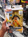 Klang, Malaysia - 25 July 2020 : Hand hold a UZUMAKI NARUTO toy character for sell in supermarket.