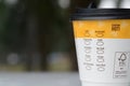 Klang, Malaysia: June 30, 2023- A back view of a McCafe coffee cup reveals a list of drink options available on the menu