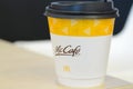 a McCafe coffee cup showcases the brand associated with McDonald\'s, known for